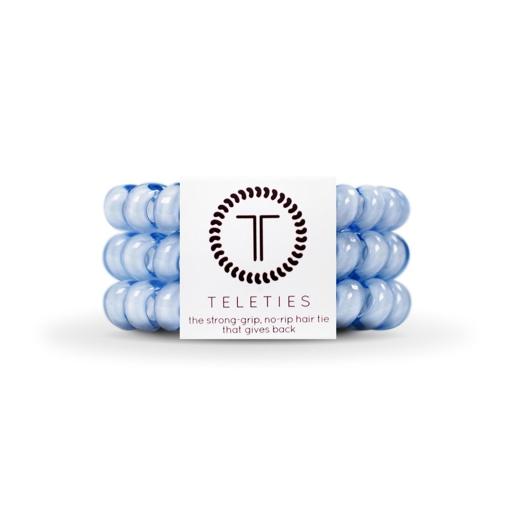 Three large spiral hair coils in washed denim with a strong grip bracelet-style silhouette.