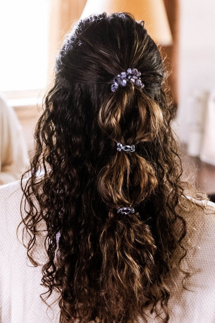 Three large black spiral hair coils with a twisted texture designed as strong-grip elastic ties.