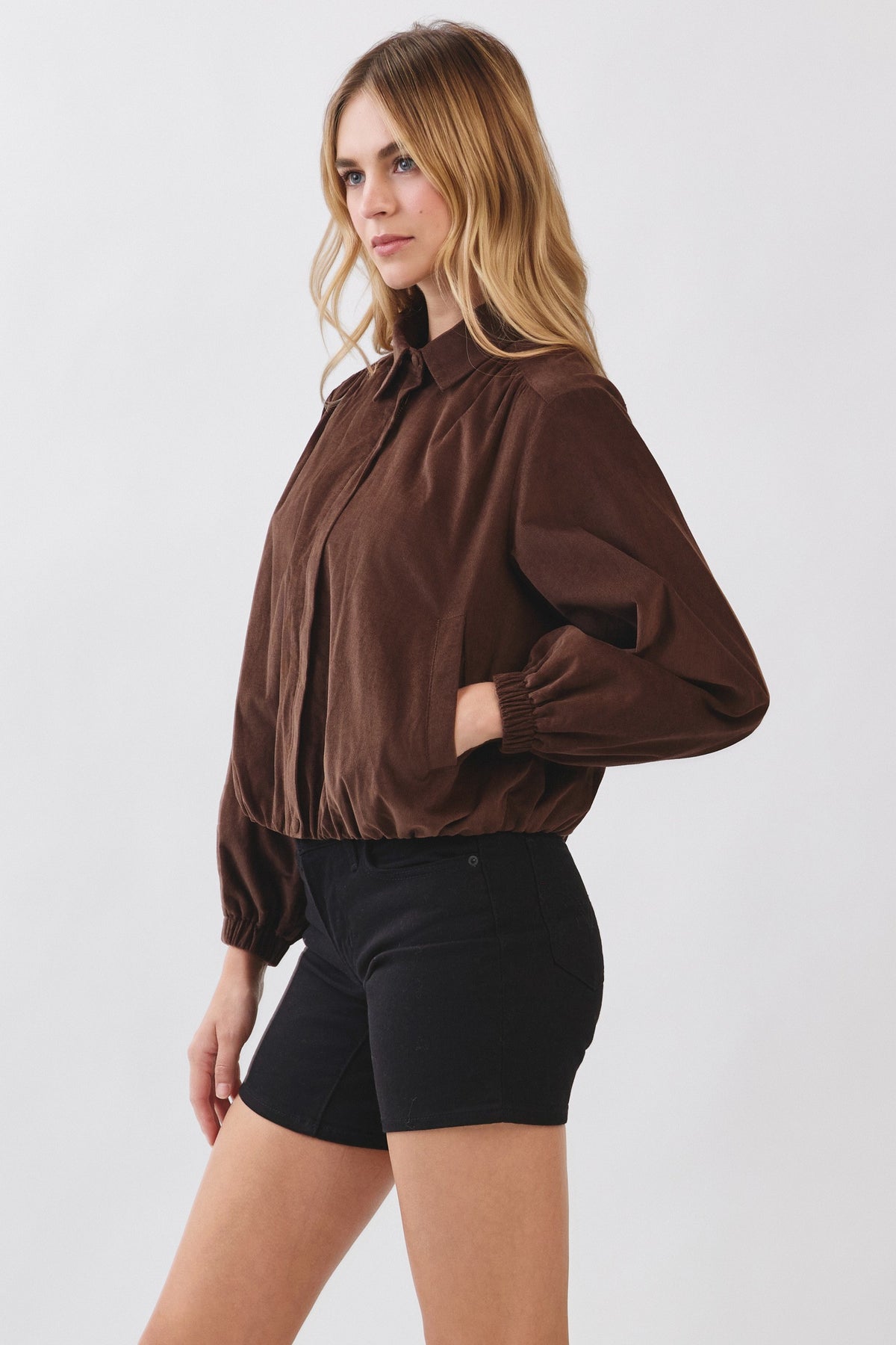 Woman wearing a brown Julie Corduroy Zip-up Collar Jacket with black shorts.