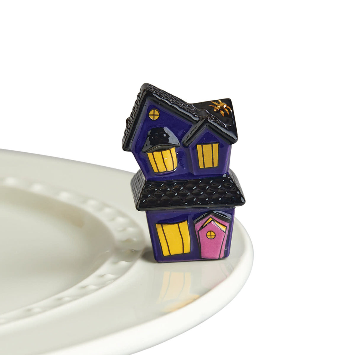 Haunted house fabric featuring creaky doors, crooked windows, and spooky patterns in dark tones.