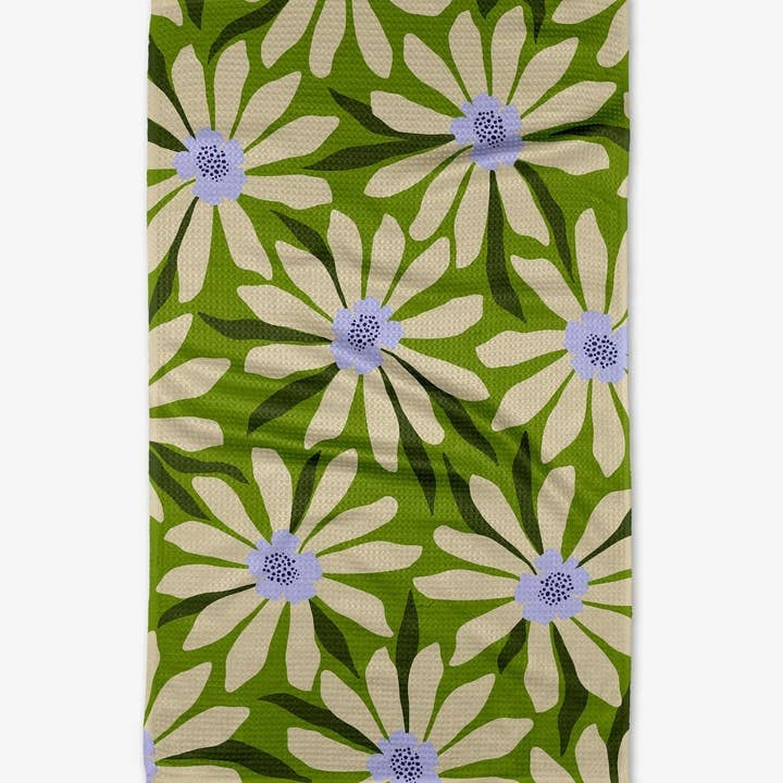 Spring tea towel with waffle weave texture in light green floral pattern featuring blossoms and leaves.