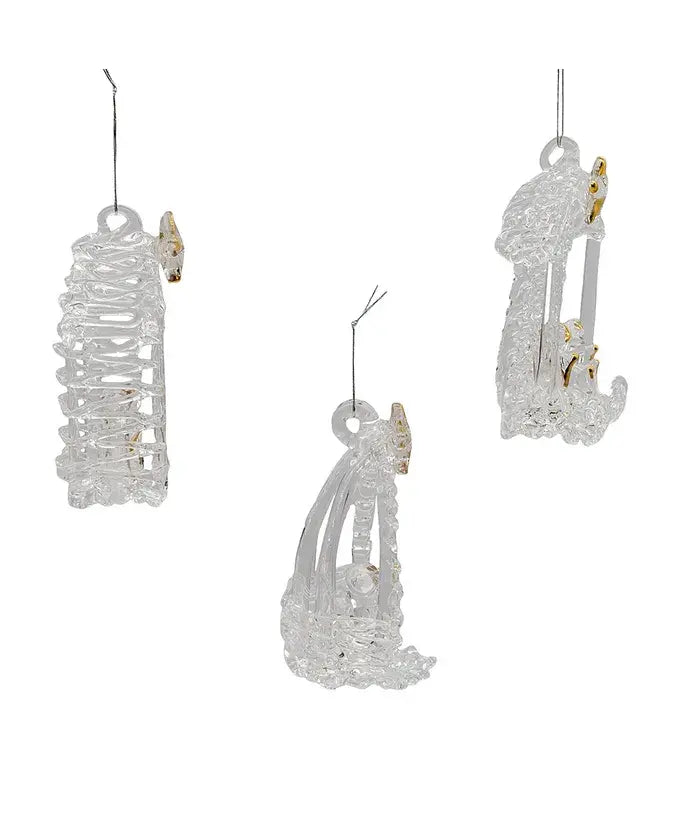 Three spun glass nativity ornaments featuring Jesus, Mary, and Joseph in a stable with gold detailing.