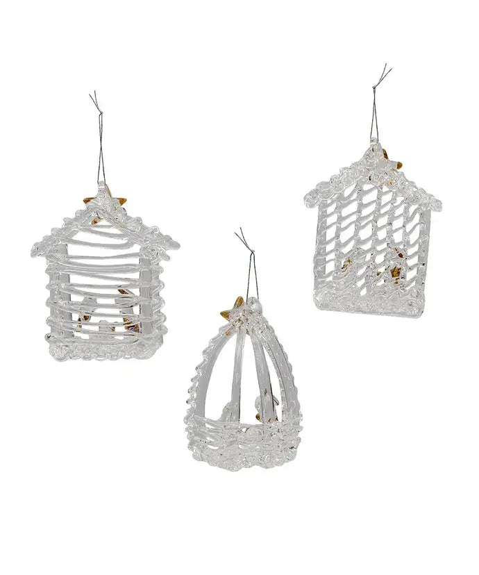 Three spun glass nativity ornaments featuring Jesus, Mary, and Joseph in a stable with gold detailing.