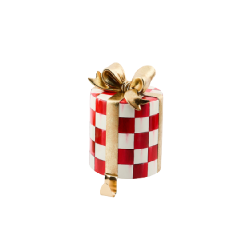 Red and white checkered gift-shaped stocking holder with a gold ribbon and bow.