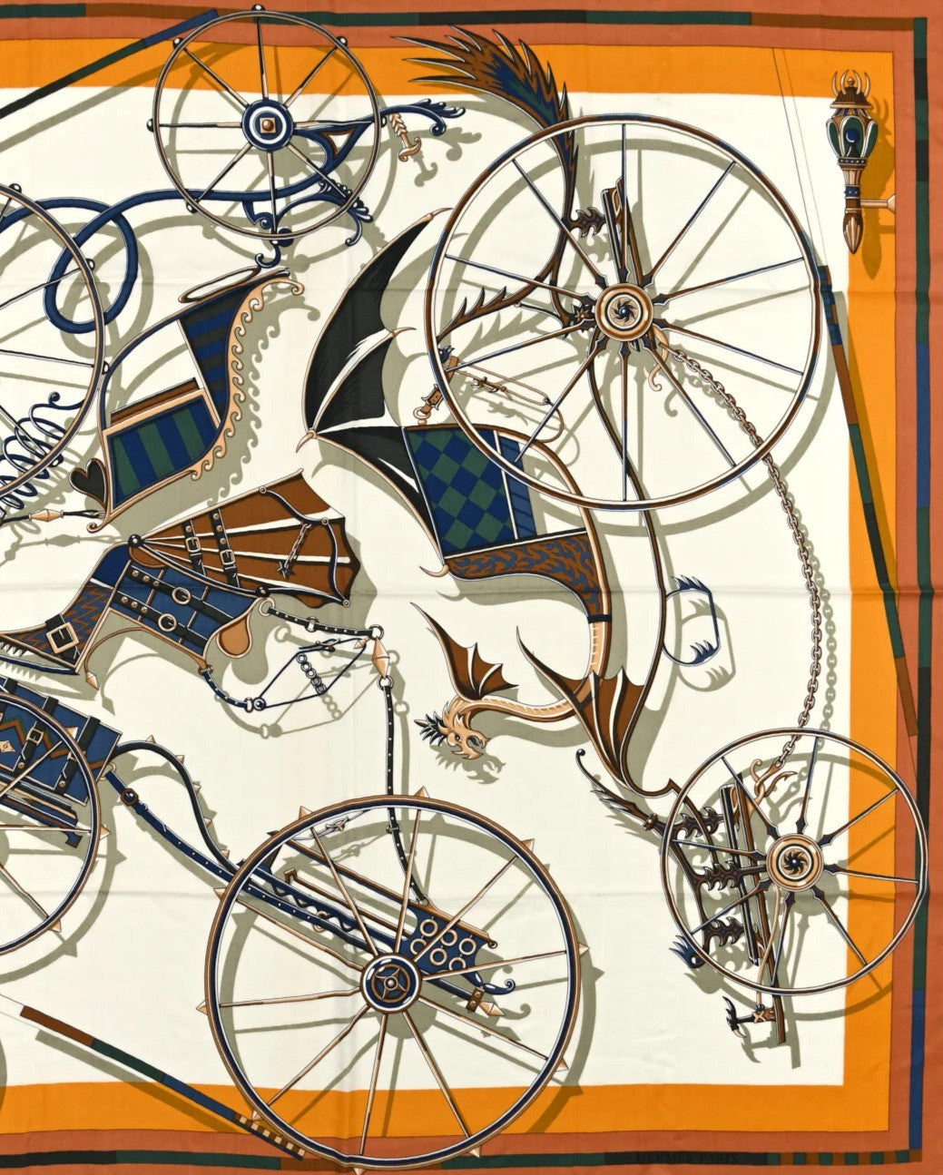 Square silk scarf with a detailed carriage and wheel motif in blue, orange, and gold tones.