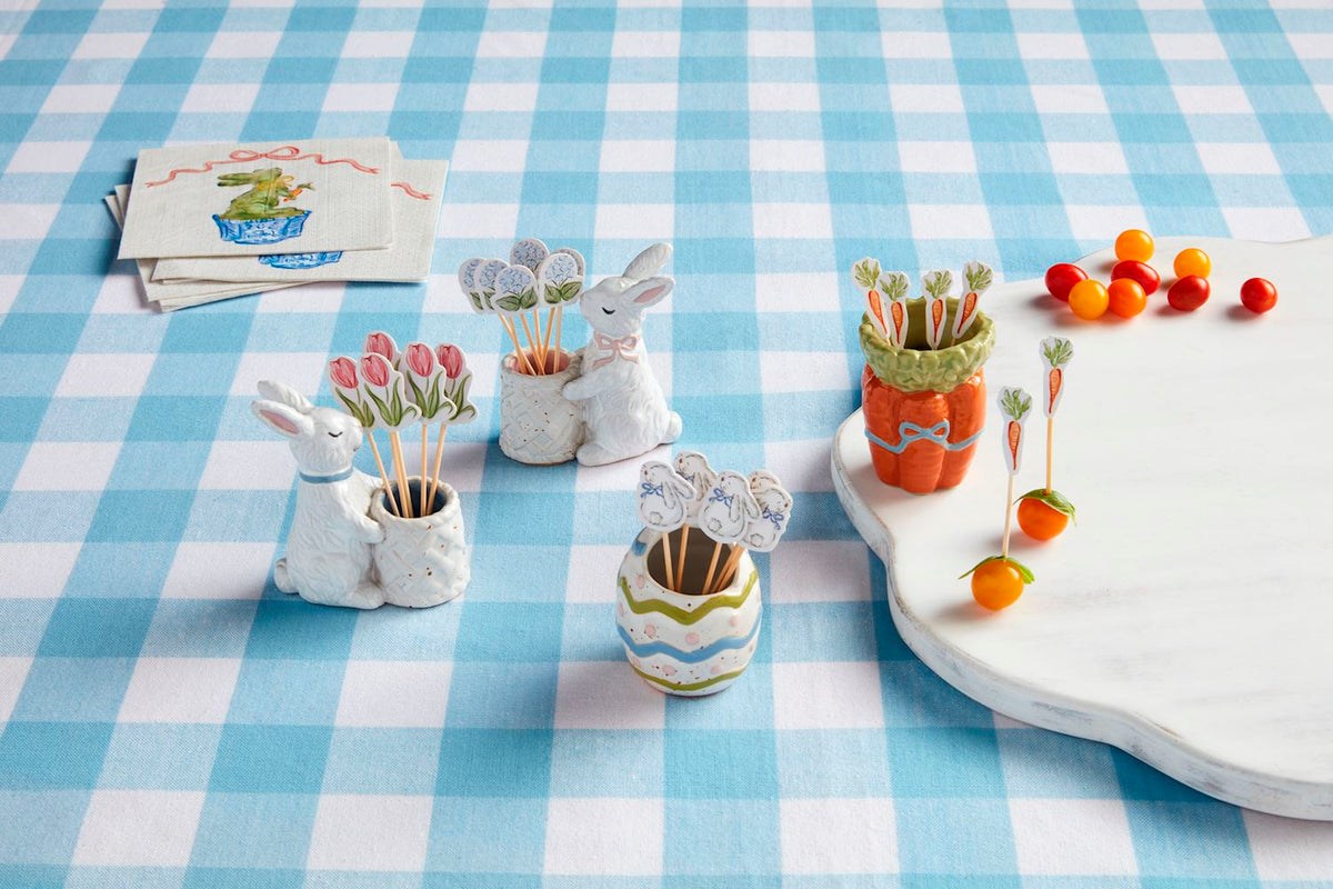 White ceramic Easter toothpick caddy with pastel floral pattern holding wooden picks