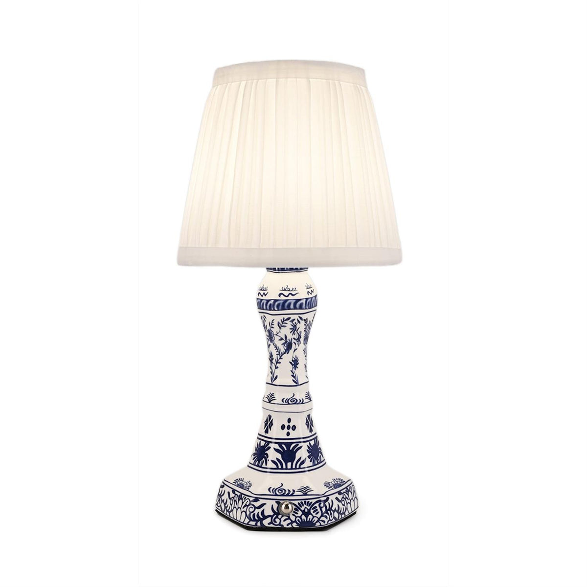 Cordless blue and white floral ceramic table lamp with a white pleated lampshade.
