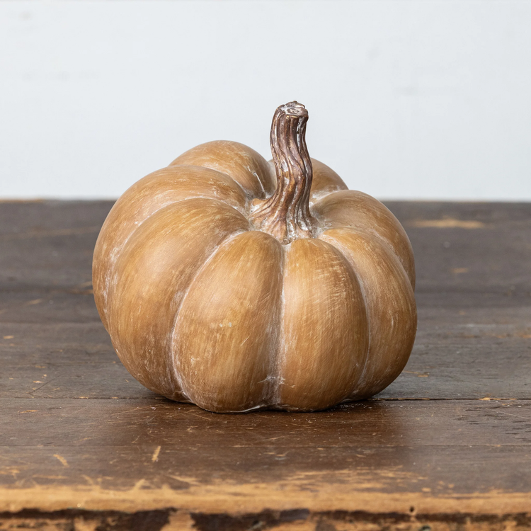 Brown resin pumpkin with textured surface and warm tones