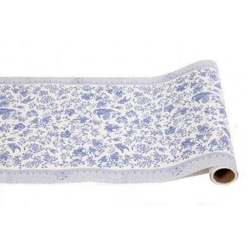 Blue peacock feather paper table runner with gold accents on a white background.