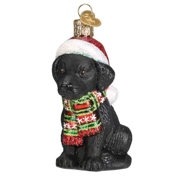 Holiday Black Labrador Puppy glass ornament wearing a red Santa hat and a festive striped scarf.