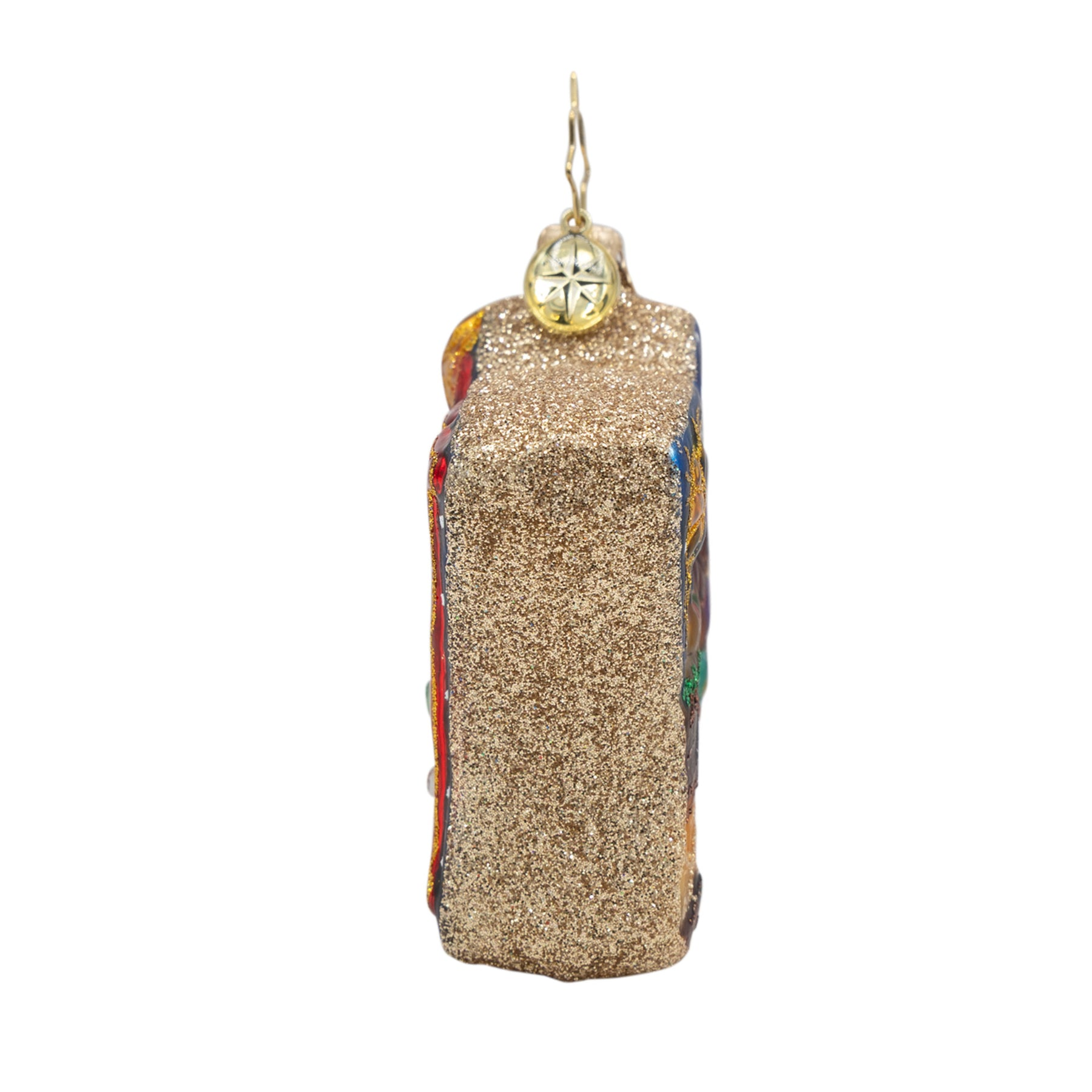 Side view of the Holy Harmony Gem glass ornament covered in gold glitter with a hanging loop.