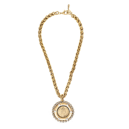 Golden chain necklace with a round coin medallion pendant framed by sparkling crystal accents.