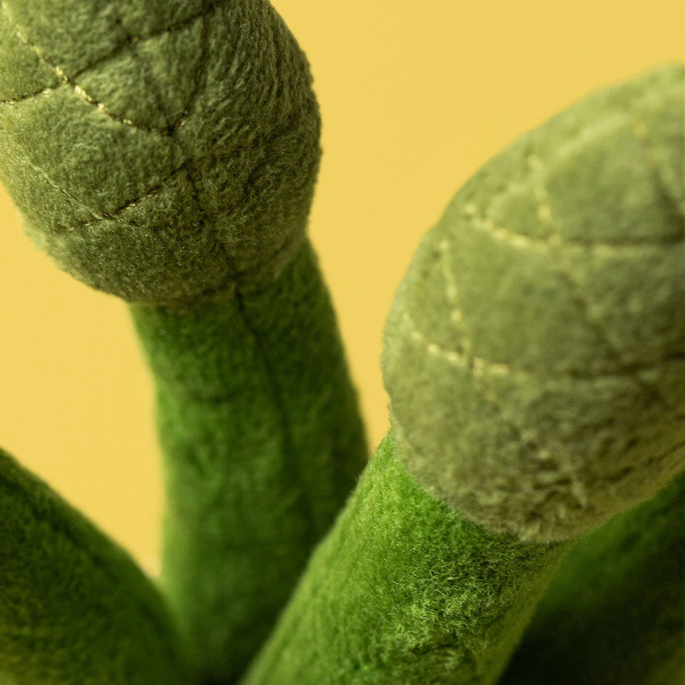 Close-up of the green textured fabric and stitched details on the tips of Amuseables Asparagus.