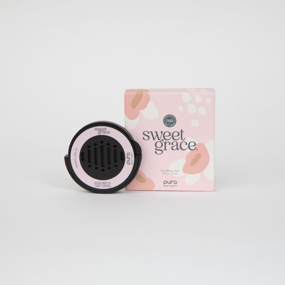 Bridgewater + Pura Sweet Grace car diffuser refill cartridge next to its pink floral packaging.