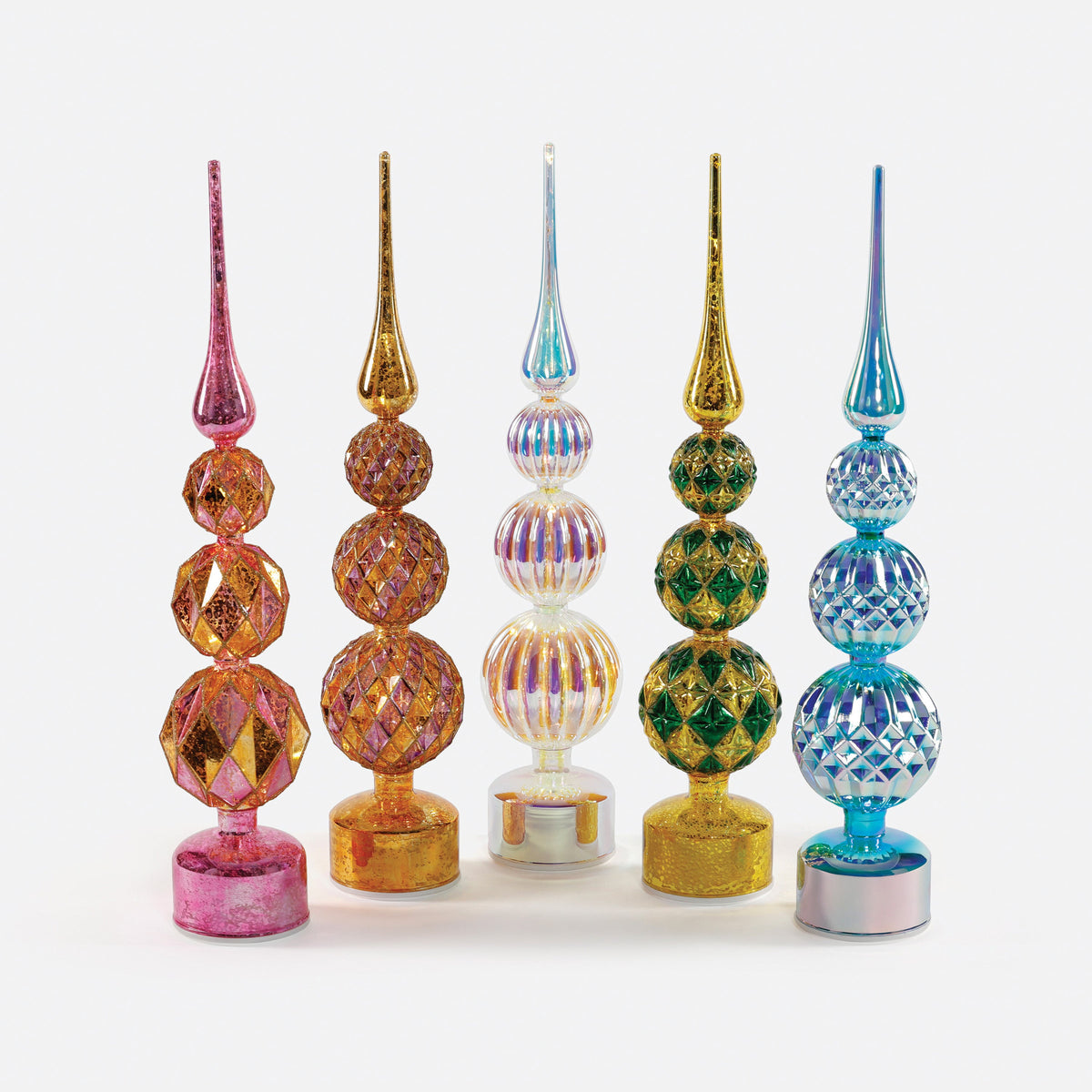 Five colorful, revolving lit glass trees in pink, gold, iridescent, green, and blue.