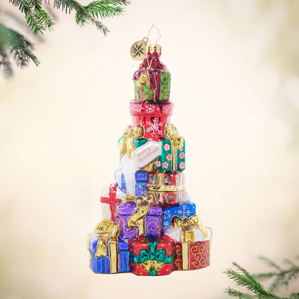 Stacked with Holiday Love: a tower of eight tiny wrapped gifts in red, green, and gold stacked vertically.