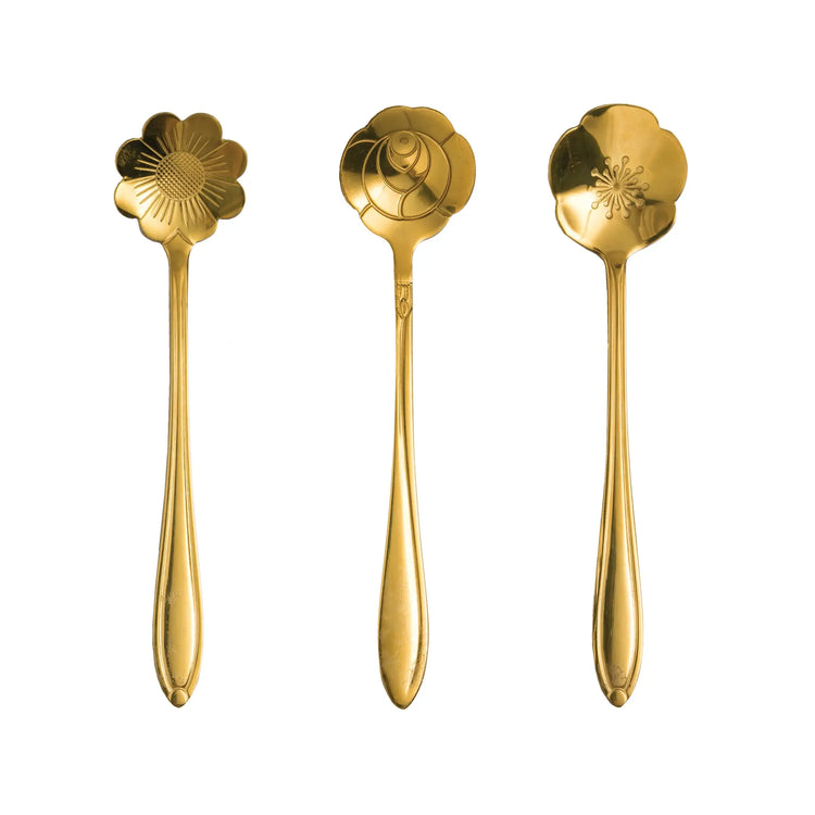 Set of stainless steel serving spoons with gold finish featuring a flower-shaped silhouette.