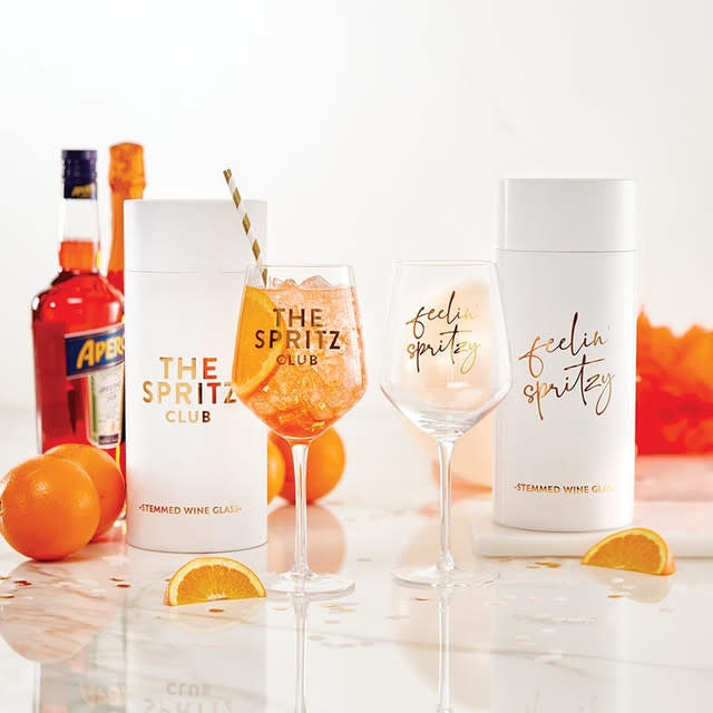 Clear glass wine glass with gold foil detailing on the stem.