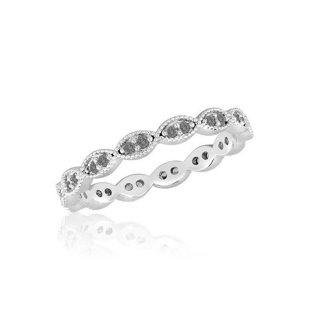 Stackable gold-tone ring with a textured band featuring an engraved floral pattern.