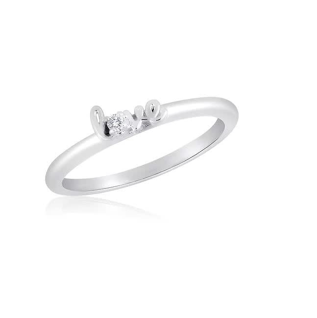 Stackable gold-tone ring with a textured band featuring an engraved floral pattern.