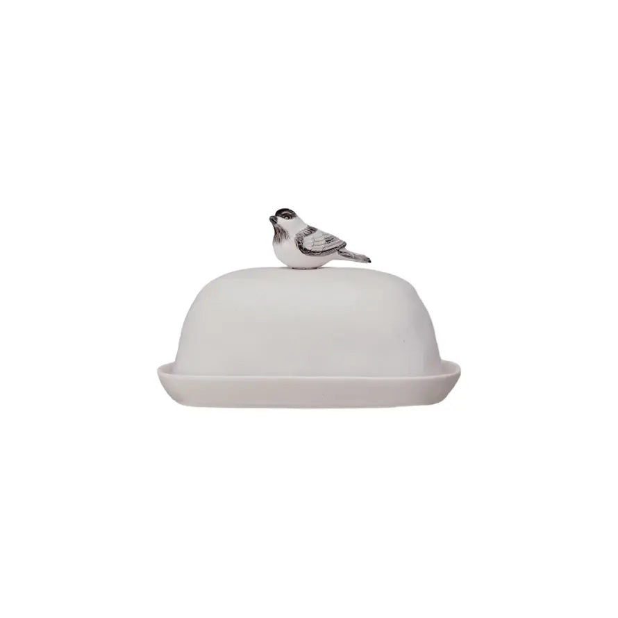 Stoneware butter dish with a bird-shaped handle in natural earth tones.