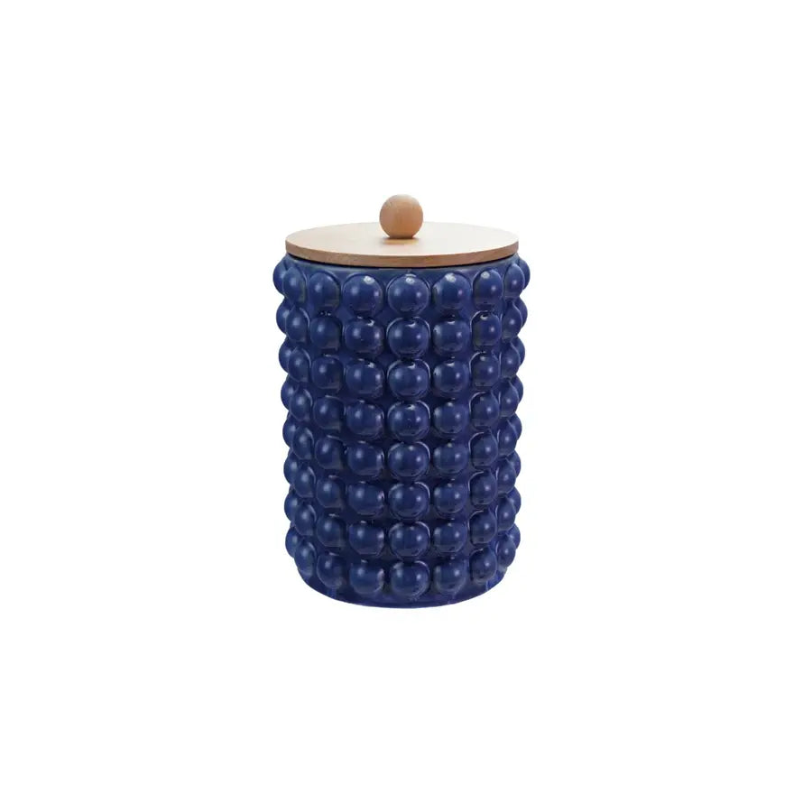 Round stoneware canister with raised dot texture and wooden lid