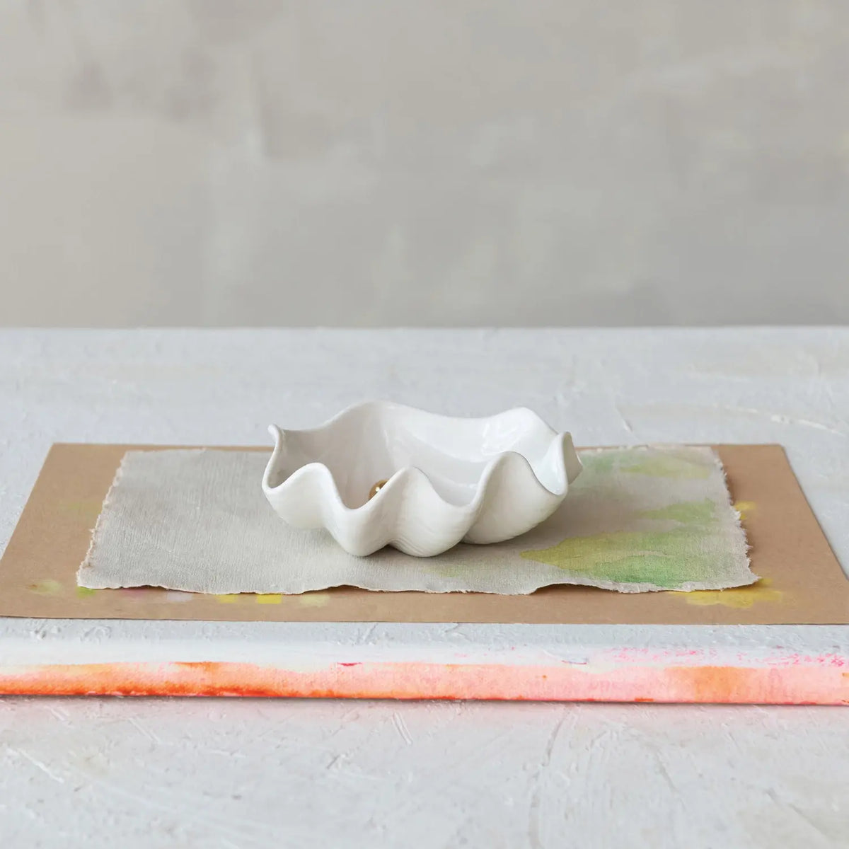 Stoneware clam shell dish with gold electroplated faux pearl accent
