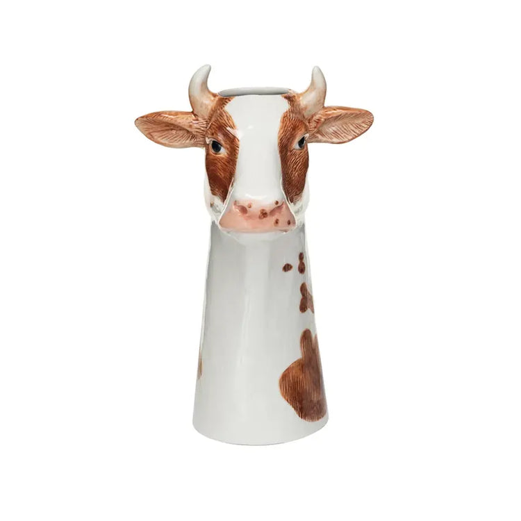 Round stoneware cow vase with hand-painted spotted pattern in natural earth tones.