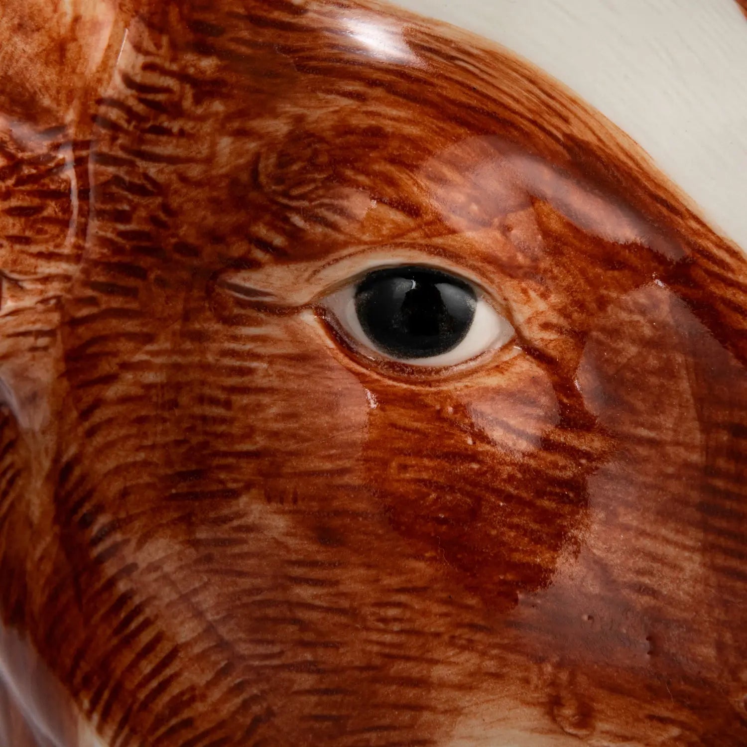 Round stoneware cow vase with hand-painted brown spots on a cream background.