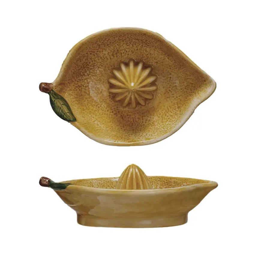 Stoneware lemon-shaped juicer in vibrant yellow with green accents