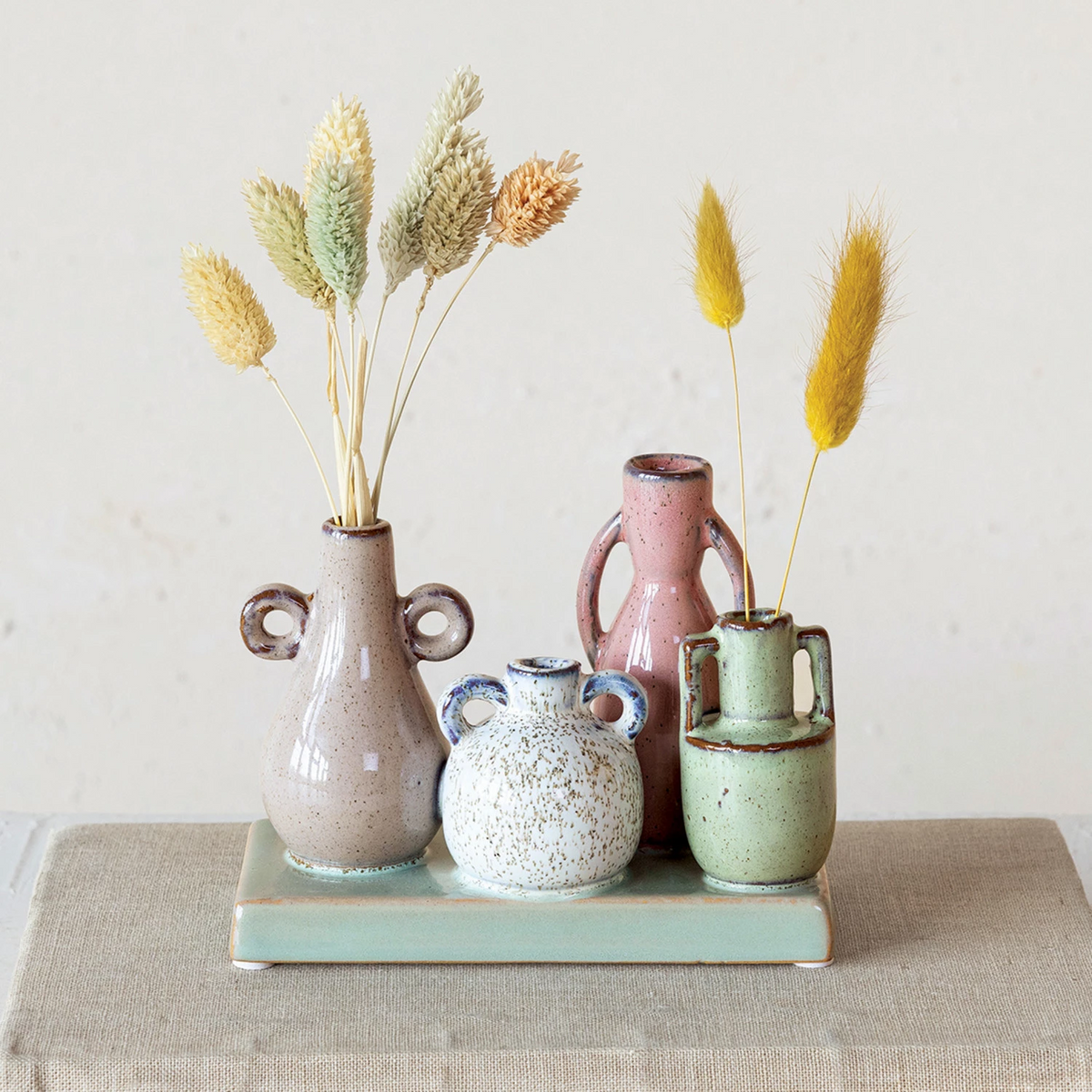 Rectangular stoneware vase with reactive glaze finish mounted on a base