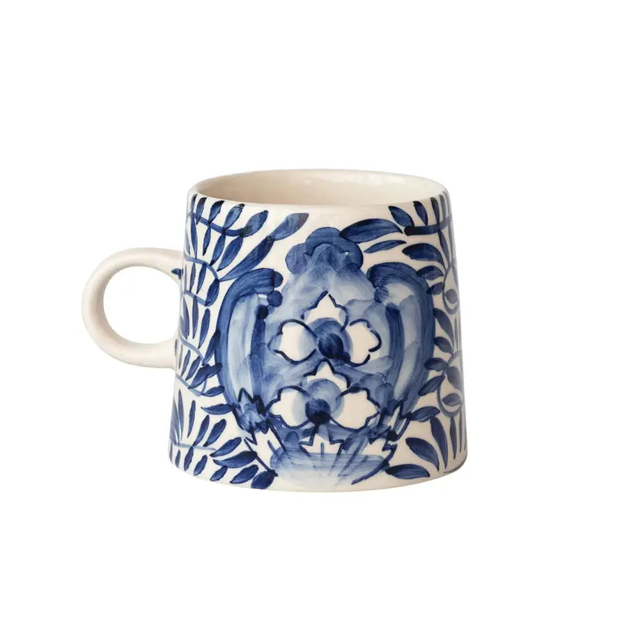Hand-painted stoneware mug with a charming decorative design on white ceramic.