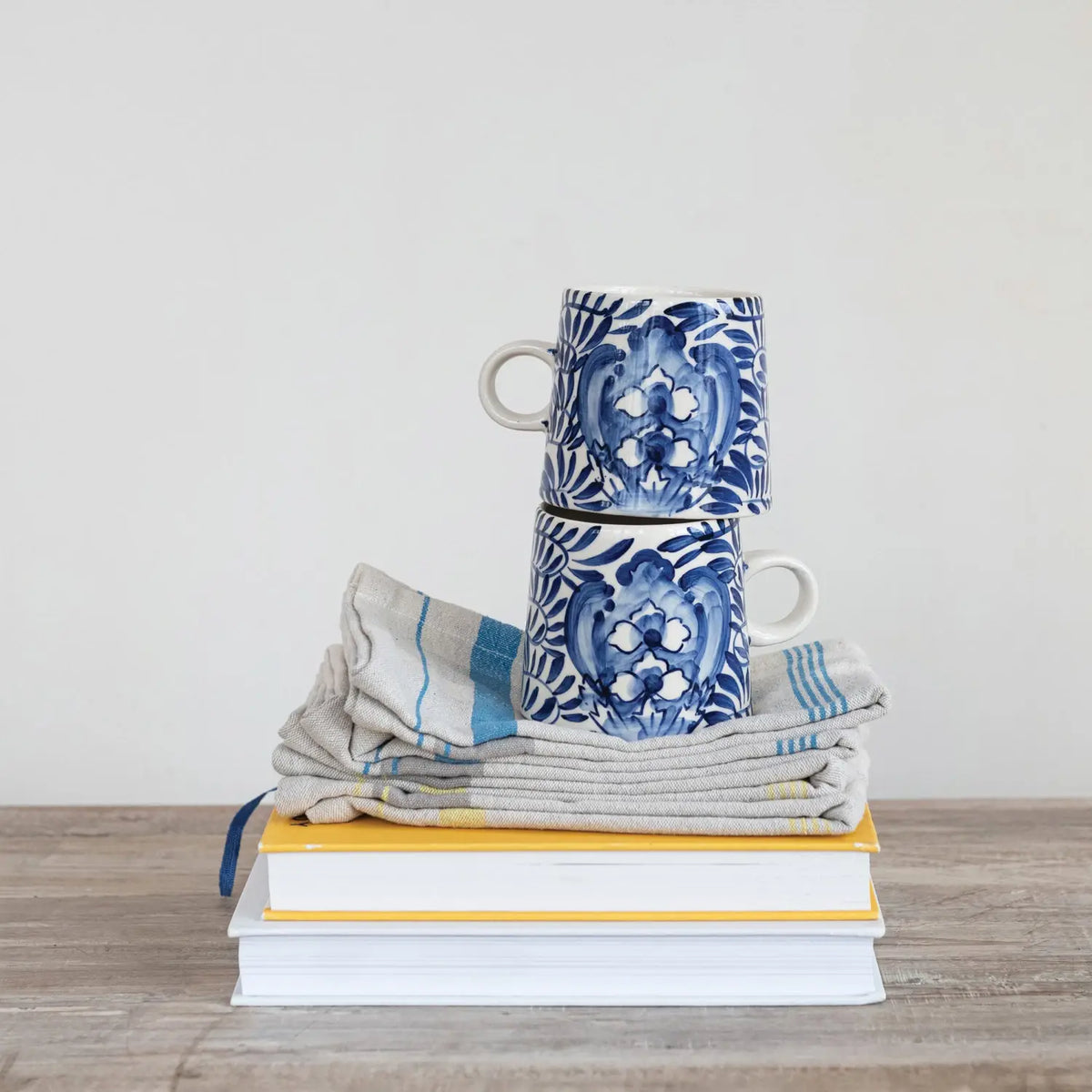 Hand-painted stoneware mug with a charming decorative design on white ceramic.