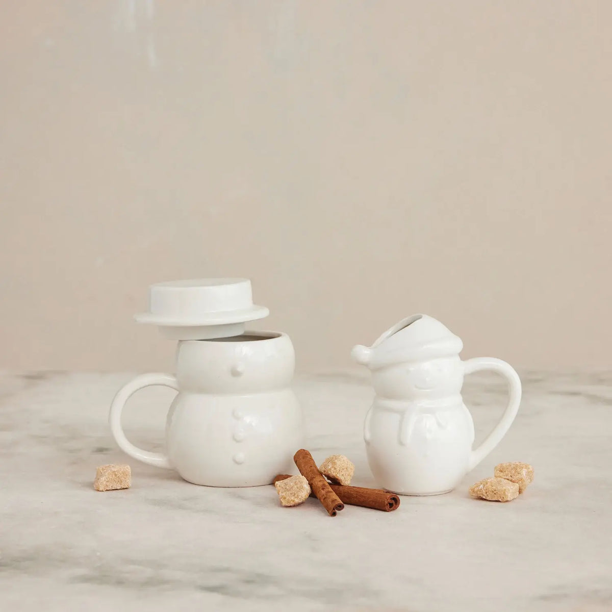 White stoneware snowman mug with a hat-shaped lid