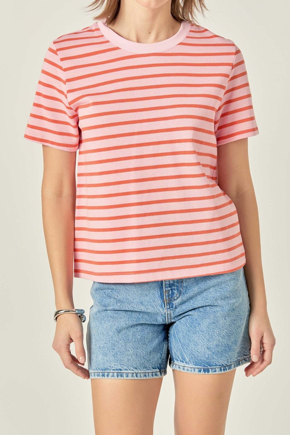 Pink and orange striped cotton t-shirt with round neckline.