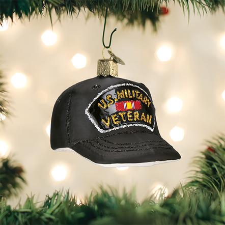 Black glass Christmas ornament shaped like a baseball cap with U.S. Military Veteran in gold glitter.
