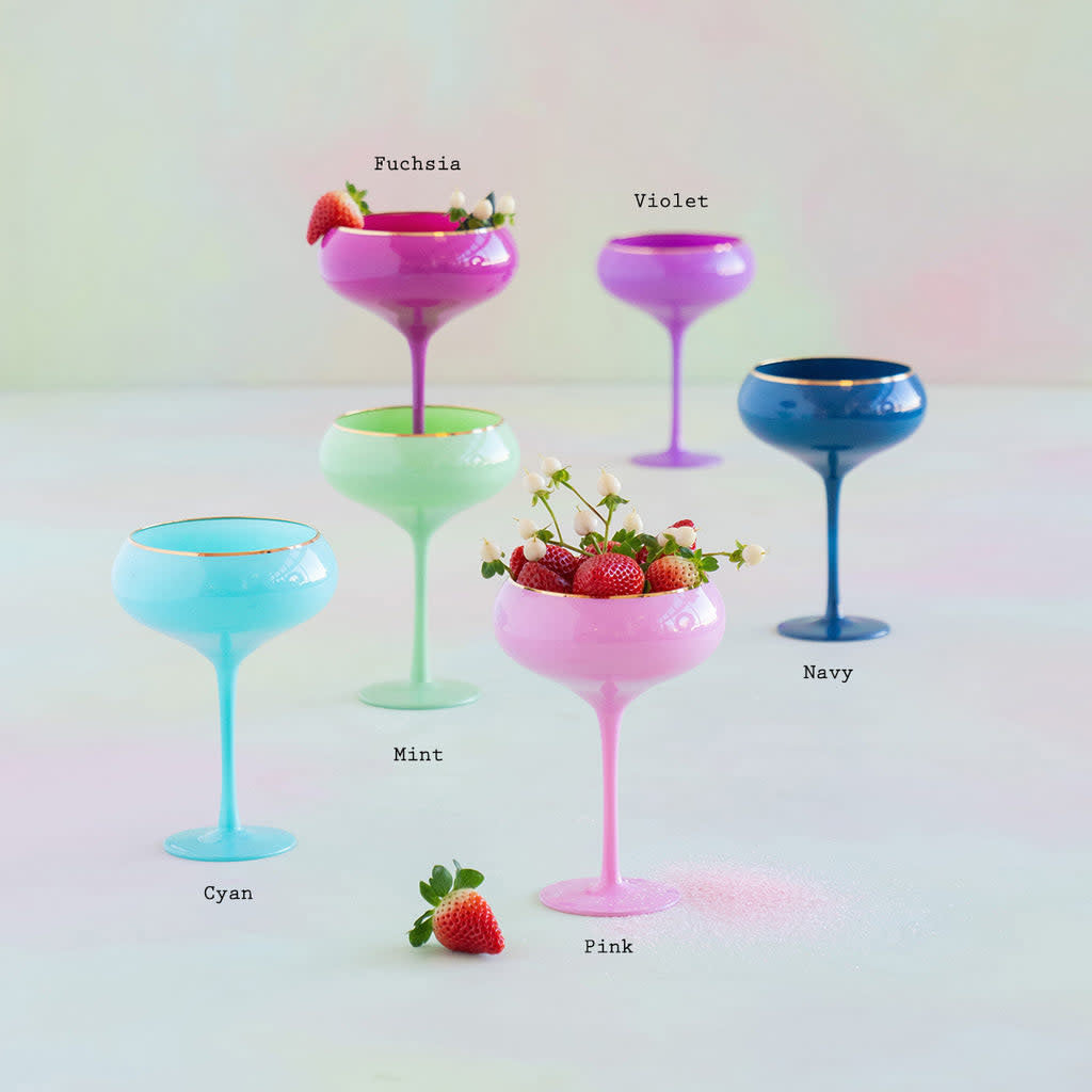 Hand-blown Sugar Plum coupe glass with gold trim and vibrant festive colors.