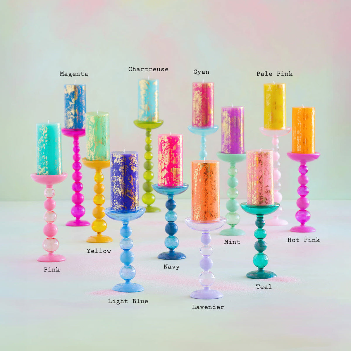 Sugar Plum glass candle holder with a finial pillar shape in saturated plum color.