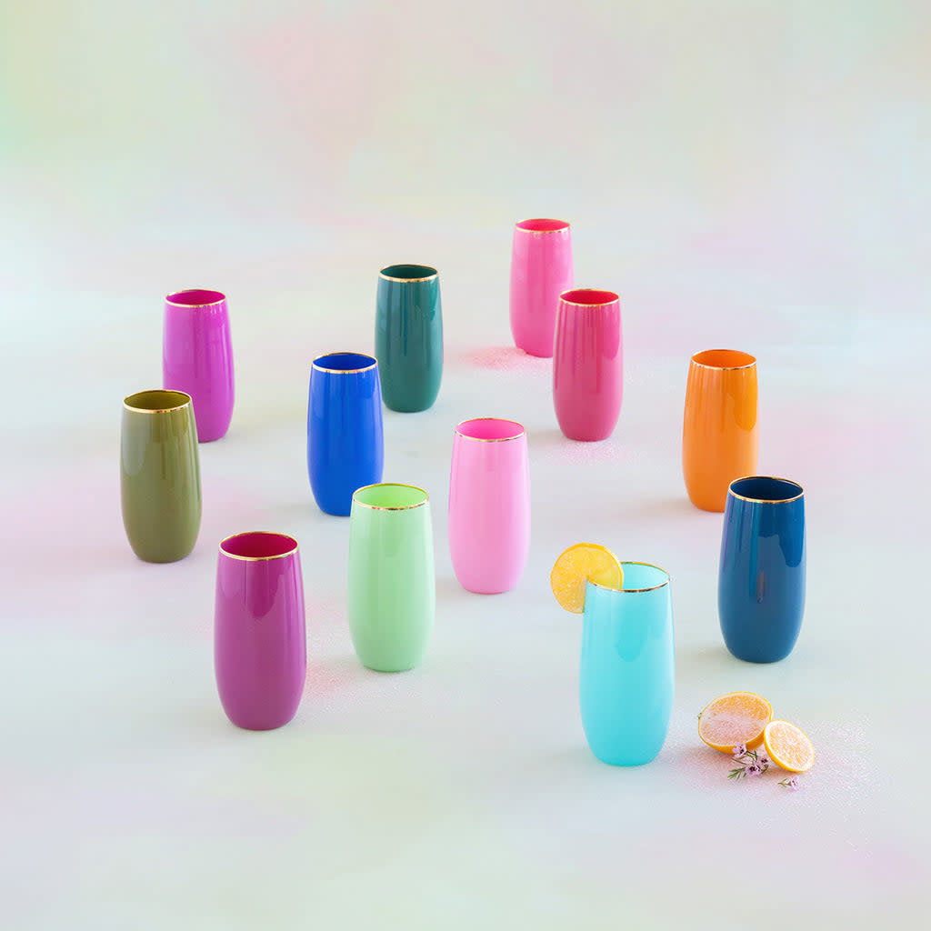 Hand-blown glass tumbler with gold trim featuring a whimsical sugar plum pattern in vibrant holiday colors.
