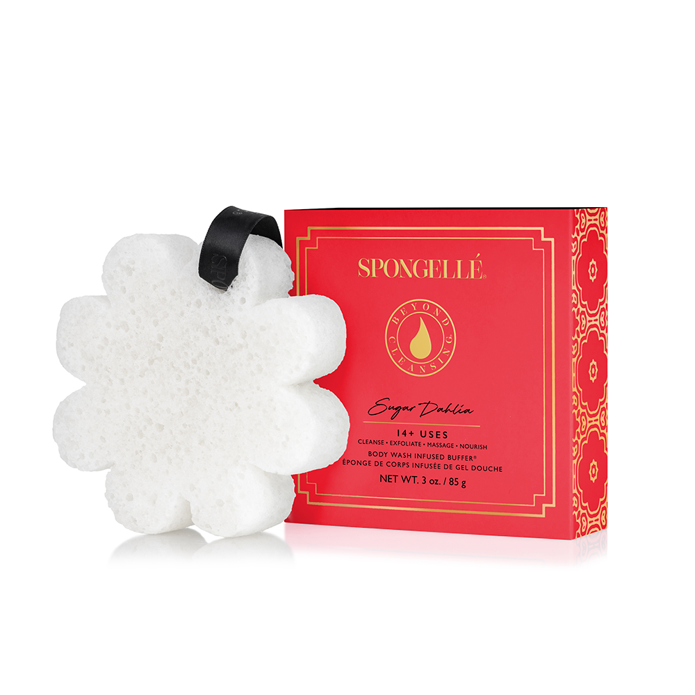 A white bath sponge with a hanging ribbon handle.