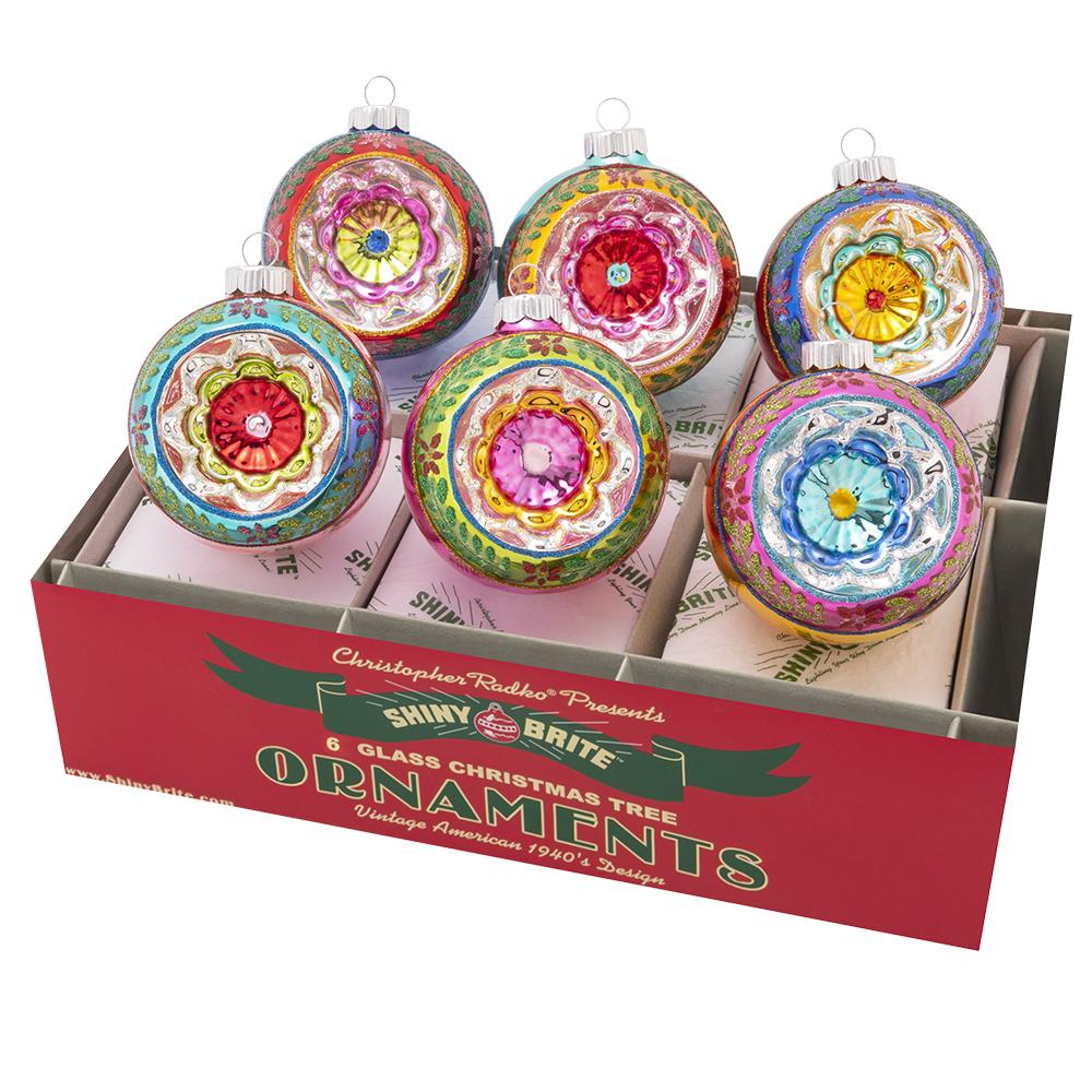 Six round Christmas confetti reflectors with a festive red and green pattern.