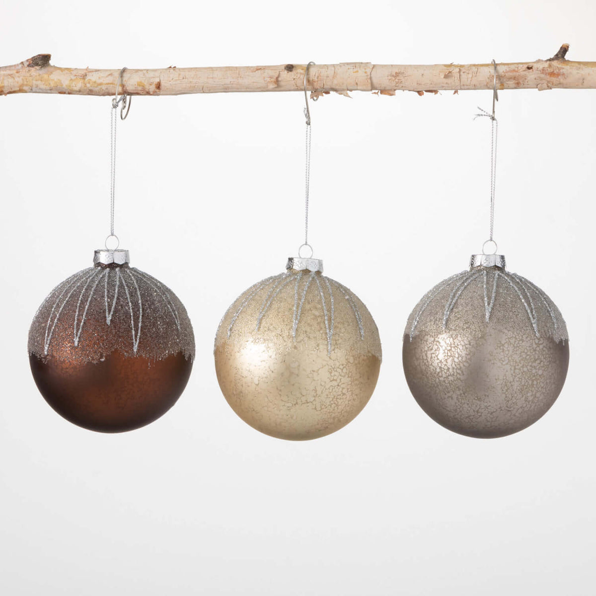 Frosted metallic ornament with a silver finish and intricate cutout patterns.