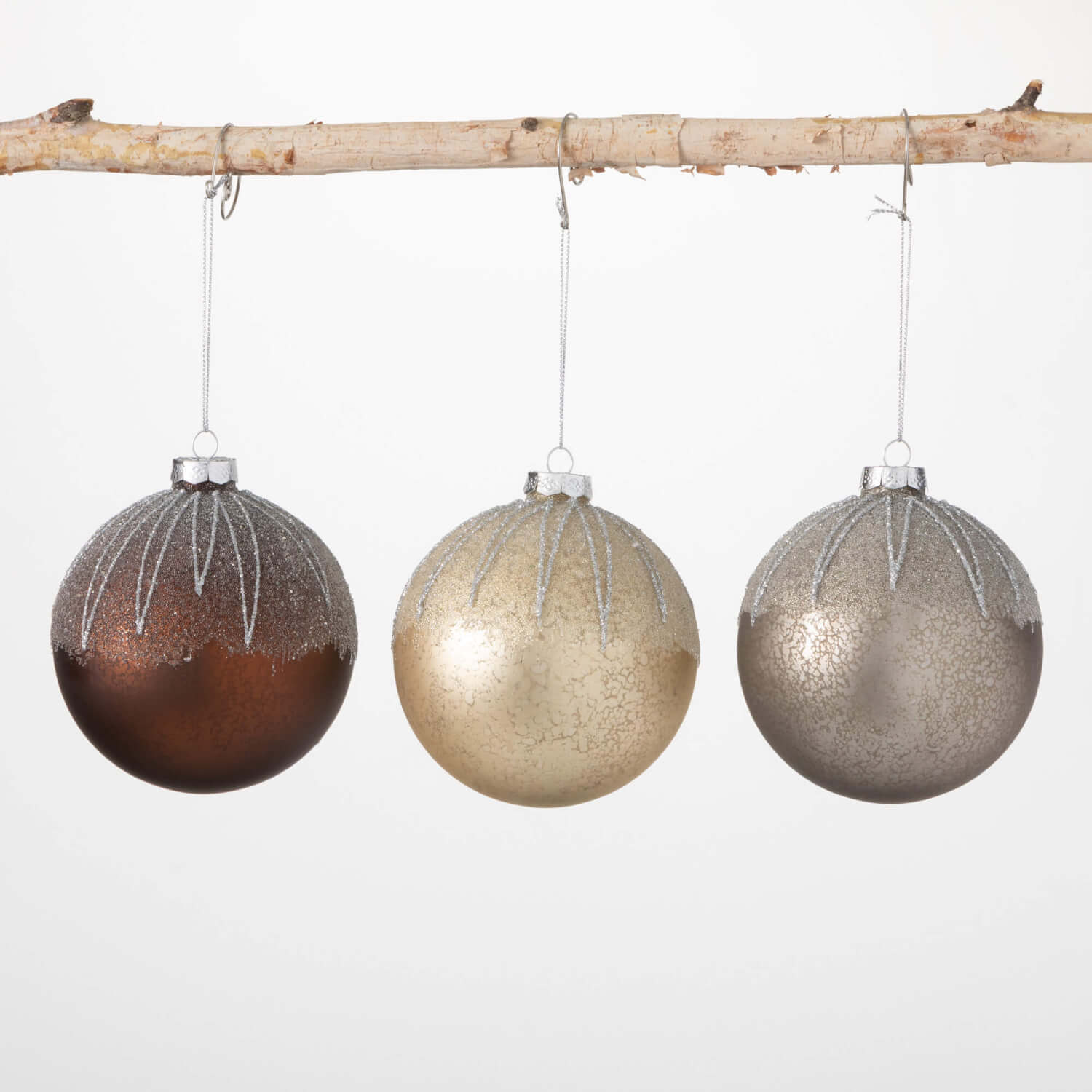 Frosted metallic ornament with a silver finish and intricate cutout patterns.