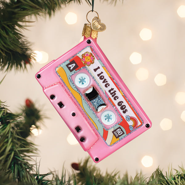 Pink cassette tape Christmas ornament with 'I love the 60s' text and retro graphics.