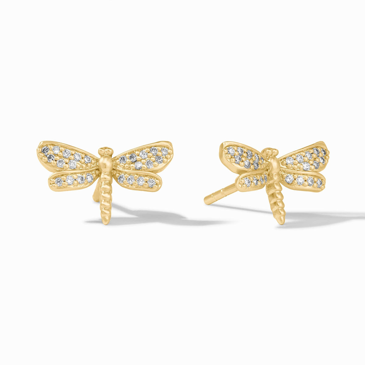 Gold-plated dragonfly stud earring with cubic zirconia pavé detailing on pierced ear.