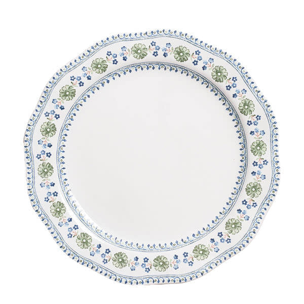 Chambray ceramic dinner plate with scalloped rim featuring intricate floral motif inspired by Spanish tiles.