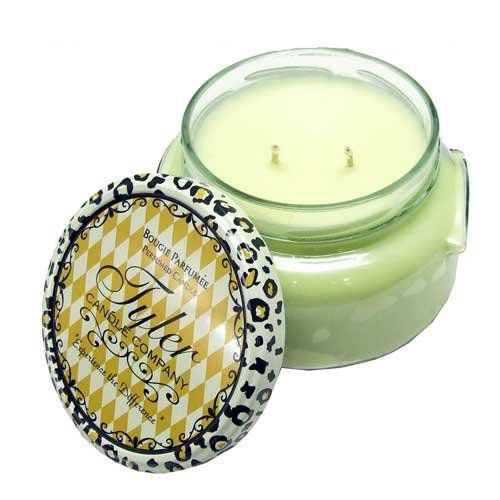 A large glass jar candle with a white wax surface inside.