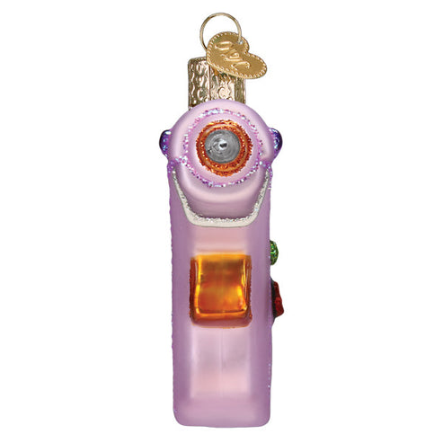 Pink glass hot glue gun Christmas ornament with glitter accents and a gold heart charm.