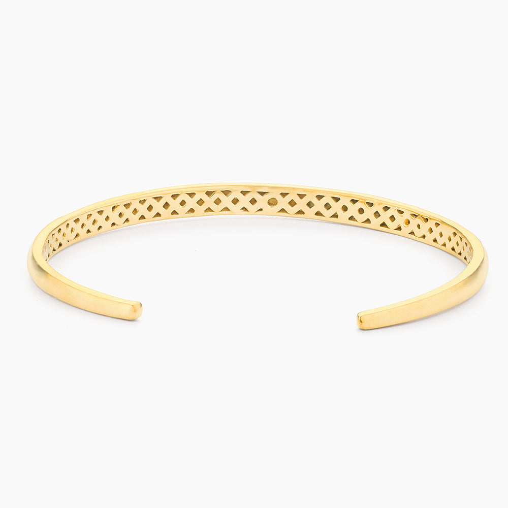 Gold-plated Lucky 7 cuff bracelet with an open design and lattice pattern interior.