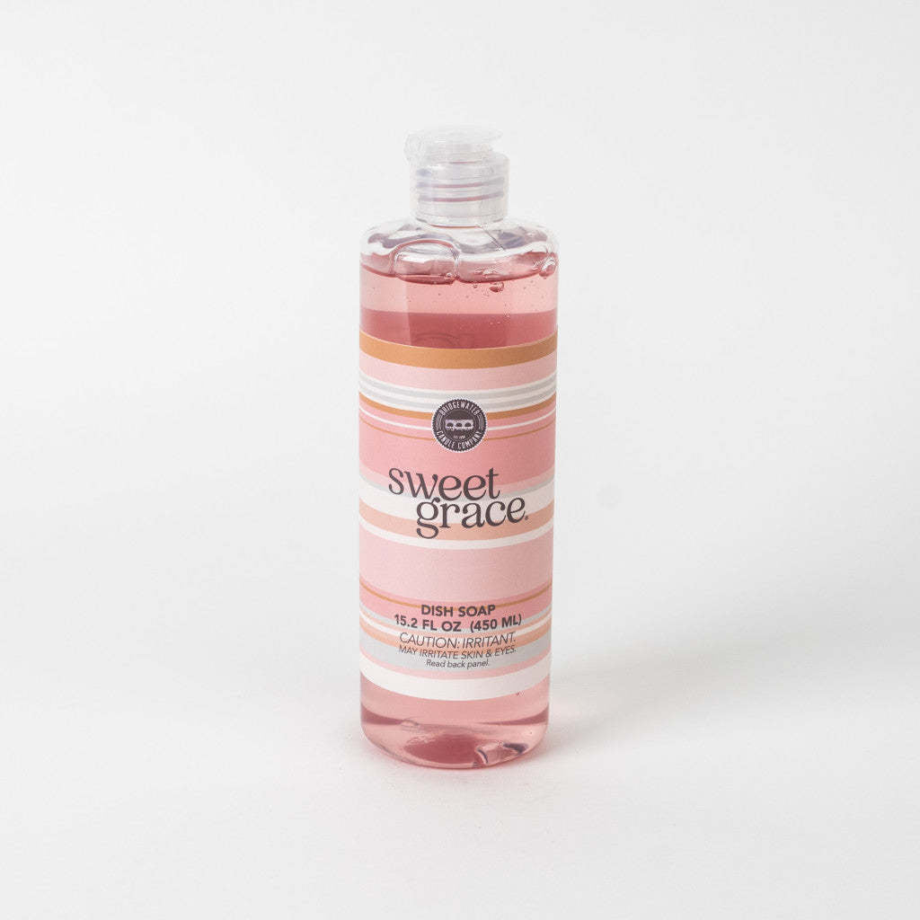 Bottle of Sweet Grace dish soap with sweet grace fragrance in a clear container.